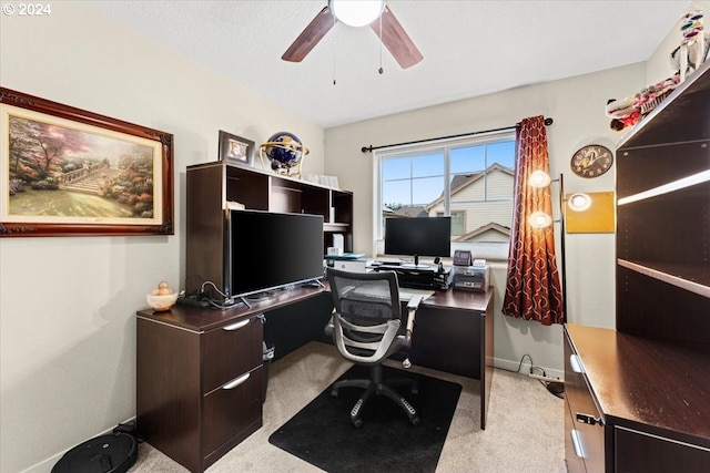 carpeted office space with ceiling fan