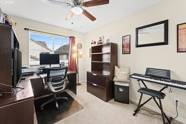 home office featuring light carpet and ceiling fan