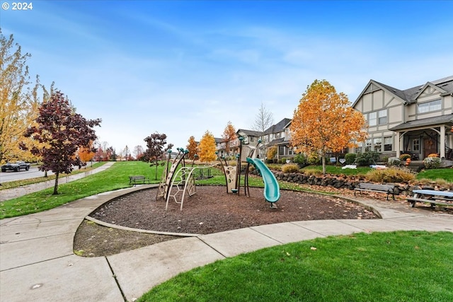 view of jungle gym featuring a lawn