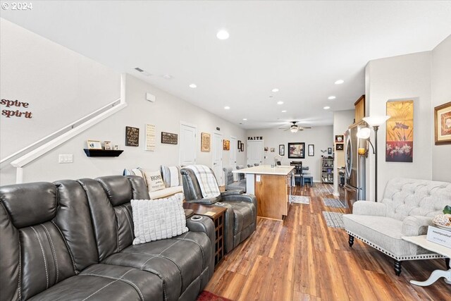 living room with wood-type flooring and ceiling fan