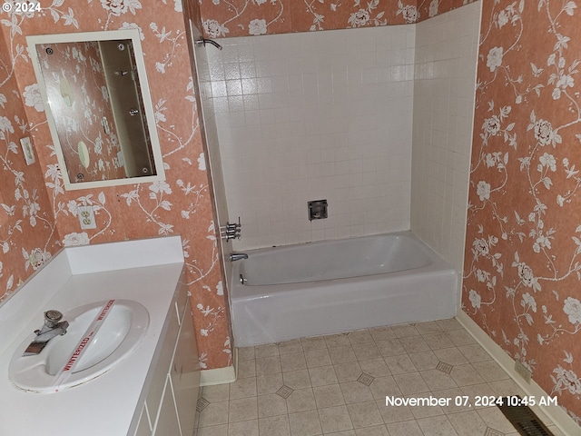 bathroom with tile patterned floors, vanity, and tiled shower / bath combo