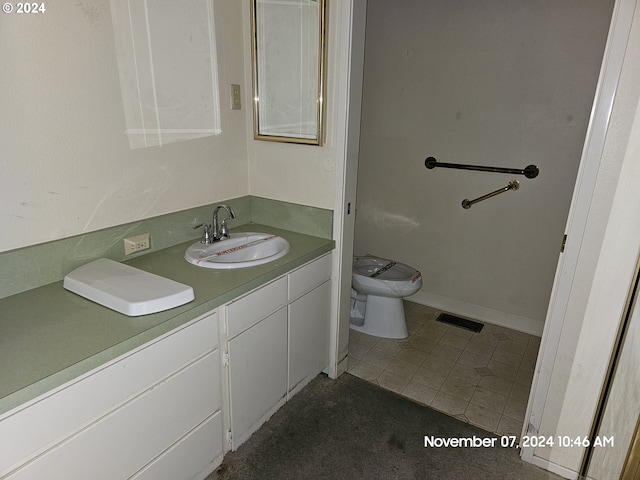 bathroom with tile patterned flooring, vanity, and toilet