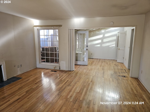 unfurnished living room with light wood-type flooring