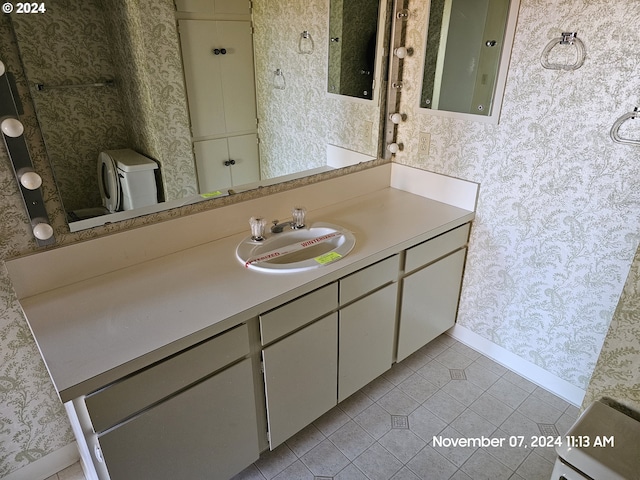 bathroom featuring tile patterned flooring, vanity, and toilet