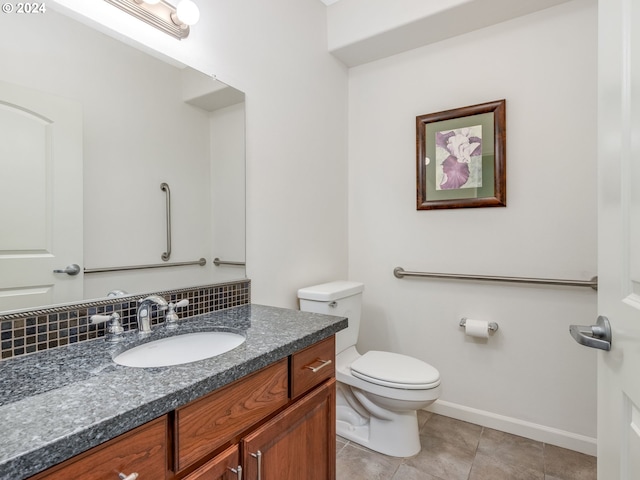 bathroom featuring backsplash, tile patterned flooring, vanity, and toilet