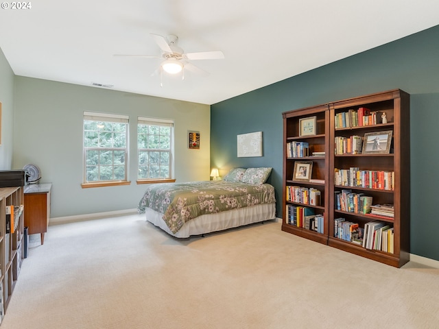 bedroom featuring light colored carpet and ceiling fan