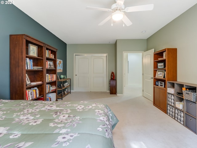 carpeted bedroom featuring a closet and ceiling fan