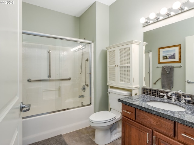 full bathroom featuring tile patterned flooring, vanity, bath / shower combo with glass door, and toilet