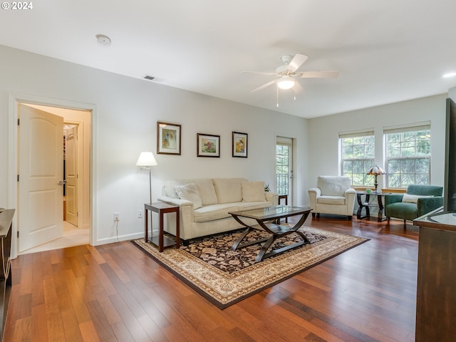 living room featuring hardwood / wood-style floors and ceiling fan