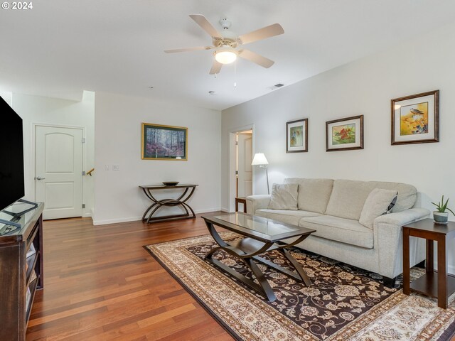 living room featuring hardwood / wood-style flooring and ceiling fan