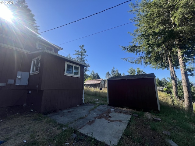 view of property exterior with a shed