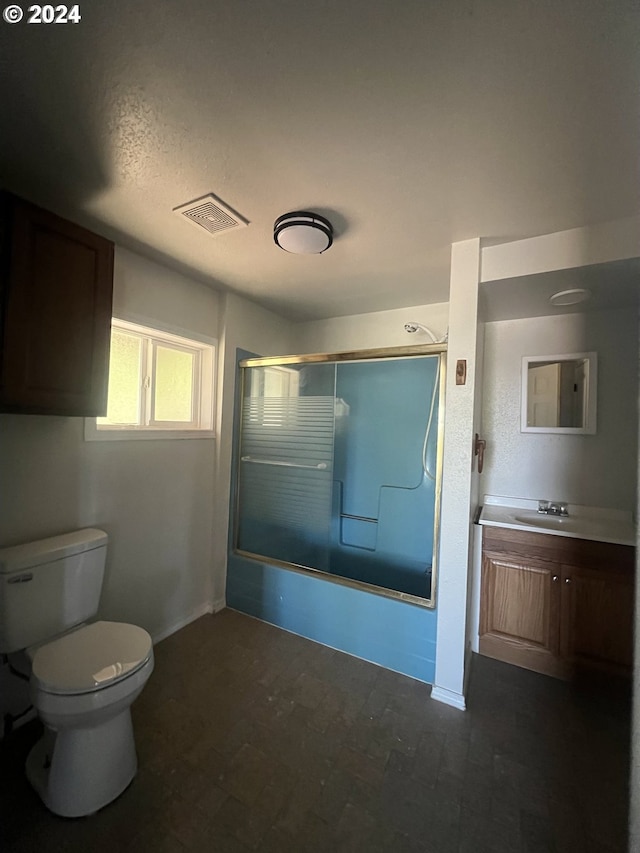 full bathroom with vanity, toilet, enclosed tub / shower combo, and a textured ceiling