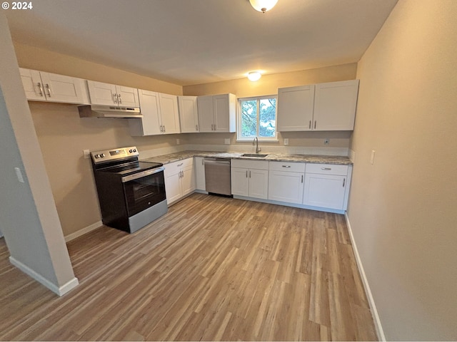 kitchen featuring white cabinetry, sink, light hardwood / wood-style flooring, and appliances with stainless steel finishes