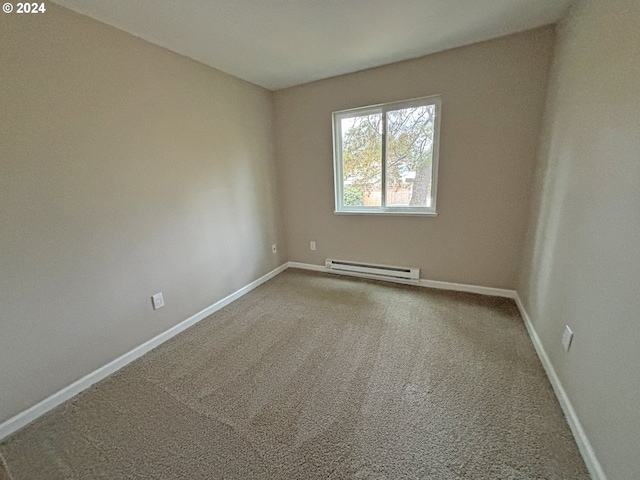 carpeted empty room featuring baseboard heating