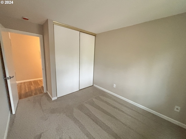 unfurnished bedroom with a closet and carpet