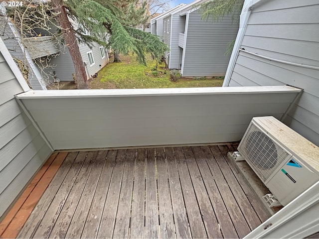 wooden deck featuring ac unit