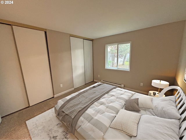 carpeted bedroom featuring baseboard heating