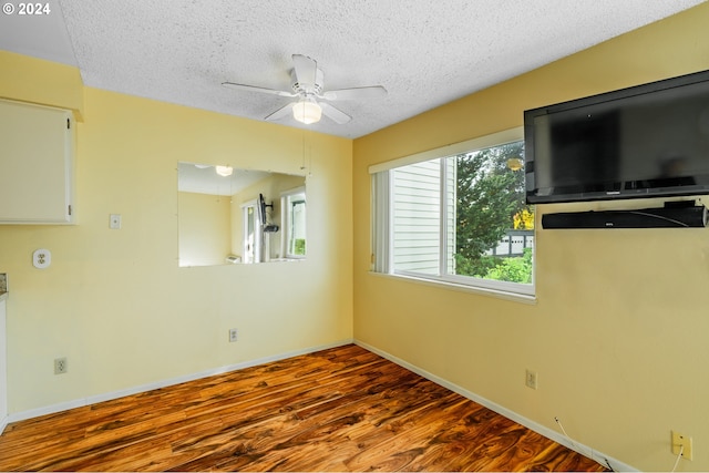 spare room featuring ceiling fan, a textured ceiling, and hardwood / wood-style floors