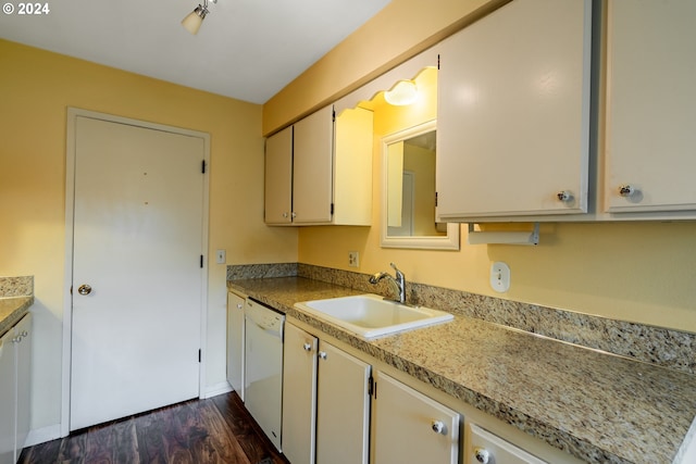 kitchen featuring dishwasher, sink, and dark hardwood / wood-style floors