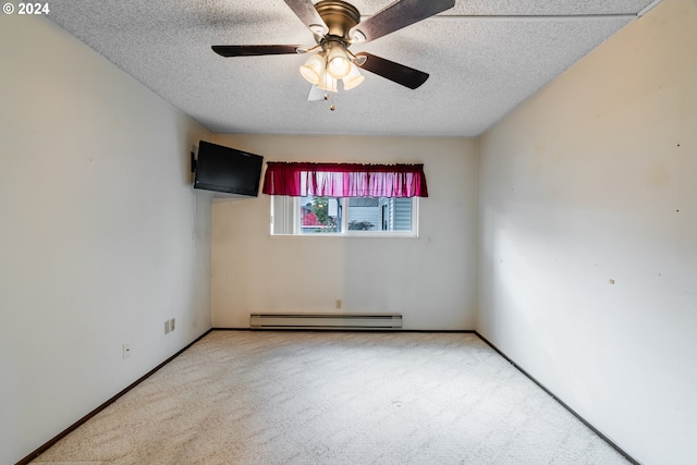 carpeted empty room with a baseboard heating unit, a textured ceiling, and ceiling fan