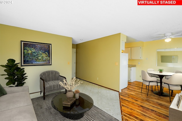 living room featuring ceiling fan and light wood-type flooring