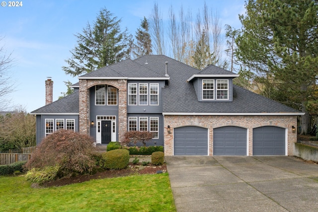 view of front of home with a garage and a front lawn