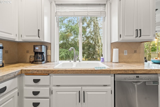 kitchen featuring white cabinets, dishwasher, sink, and tasteful backsplash