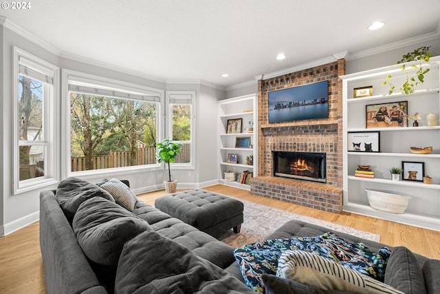 living room with a fireplace, light wood-type flooring, plenty of natural light, and ornamental molding