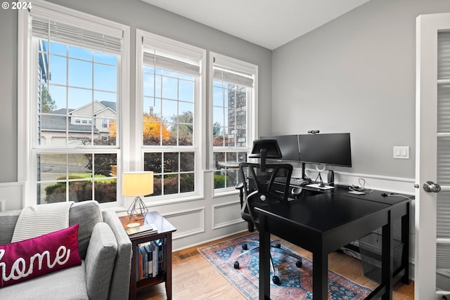 home office with wood-type flooring