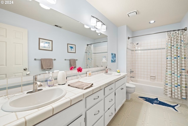 full bathroom featuring vanity, shower / bath combination with curtain, and toilet