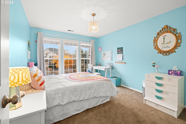 bedroom featuring carpet flooring and an inviting chandelier