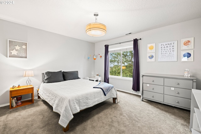 bedroom with carpet flooring and a textured ceiling