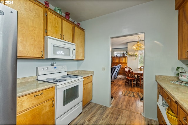 30274 Peoria Rd, Shedd, OR 97377 - kitchen with white appliances, wood finished floors, light countertops, and brown cabinets