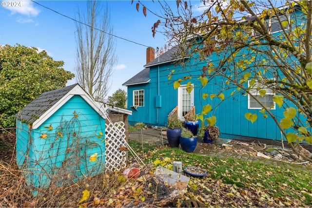 30274 Peoria Rd, Shedd, OR 97377 - view of property exterior with a chimney, roof with shingles, and an outdoor structure