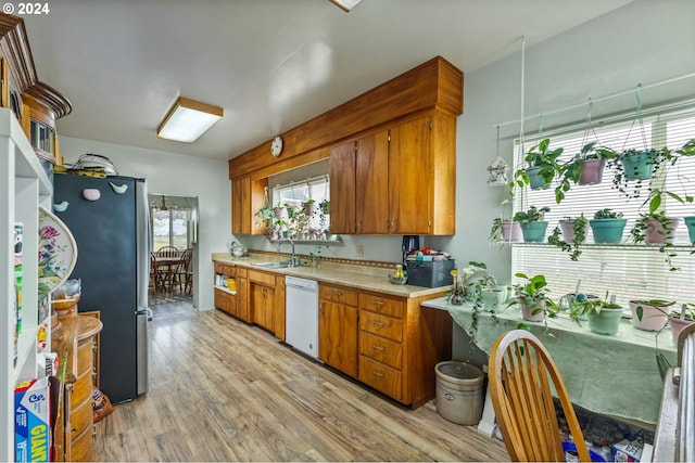 30274 Peoria Rd, Shedd, OR 97377 - kitchen with white dishwasher, a sink, light countertops, freestanding refrigerator, and brown cabinetry
