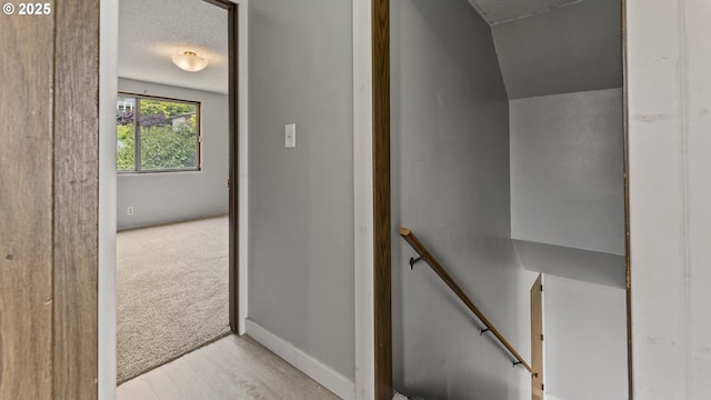 976 E St, Coos Bay, OR 97420 - stairs with a textured ceiling and wood finished floors