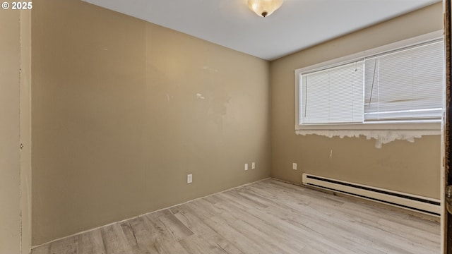 976 E St, Coos Bay, OR 97420 - empty room with a baseboard radiator and wood finished floors