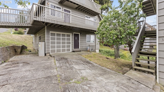 976 E St, Coos Bay, OR 97420 - view of side of property featuring stairs, driveway, an attached garage, and a wooden deck