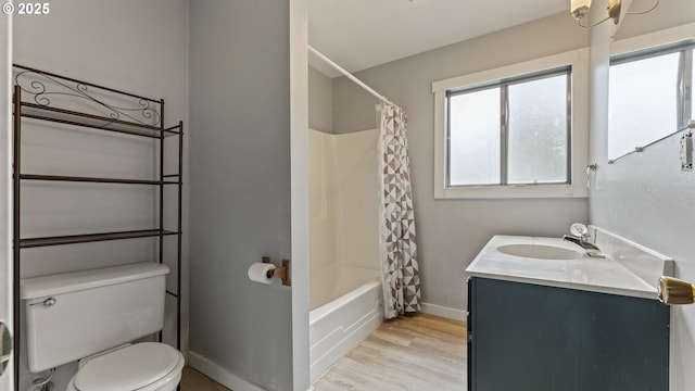 976 E St, Coos Bay, OR 97420 - bathroom with toilet, wood finished floors, vanity, baseboards, and shower / tub combo