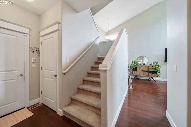 stairway featuring wood-type flooring