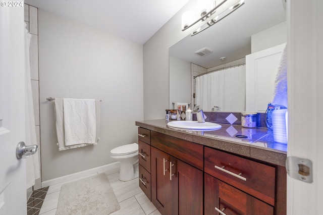 bathroom with vanity, toilet, and tile patterned flooring