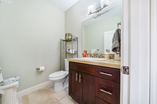 bathroom with tile patterned floors, vanity, and toilet