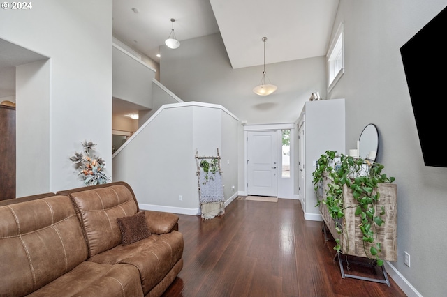 entryway featuring a high ceiling and dark wood-type flooring