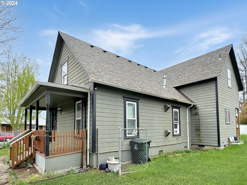 back of house with a yard and a porch