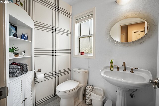 bathroom with tile patterned flooring and toilet