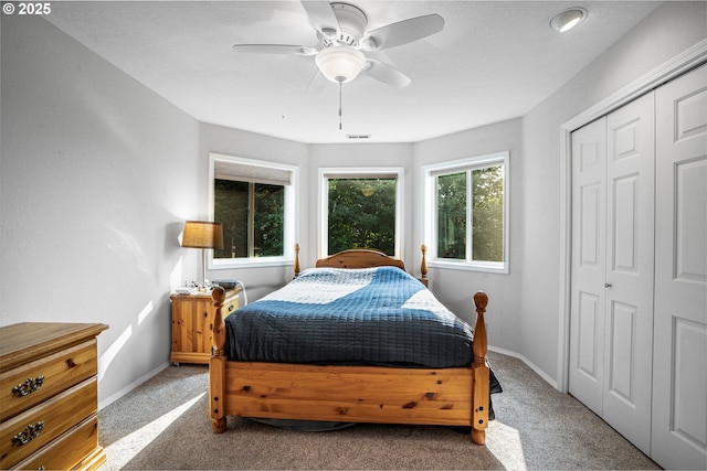 bedroom featuring carpet, a closet, ceiling fan, and baseboards