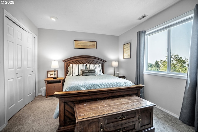 bedroom with light carpet, visible vents, and baseboards