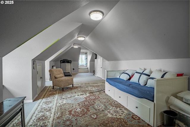 bedroom featuring light colored carpet, vaulted ceiling, and baseboards