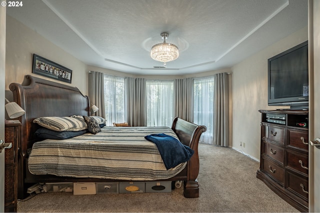 bedroom featuring multiple windows, a chandelier, light carpet, and a textured ceiling