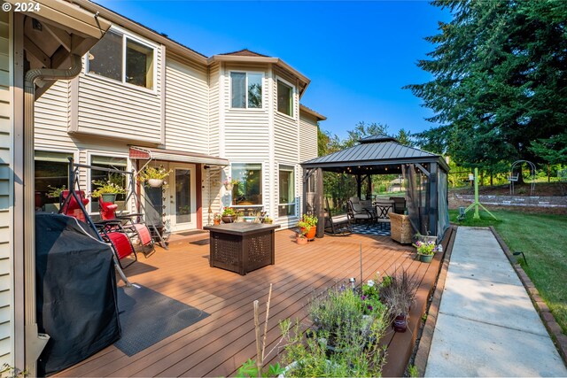 back of property featuring a gazebo, a yard, and central air condition unit